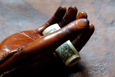 High angle view of paper currency in hand sculpture on table