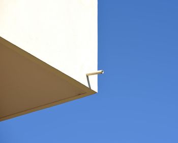 Low angle view of built structure against clear blue sky