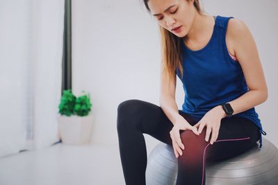 Midsection of woman sitting at home