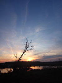 Scenic view of silhouette landscape against sky at sunset