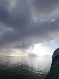 Scenic view of sea against storm clouds
