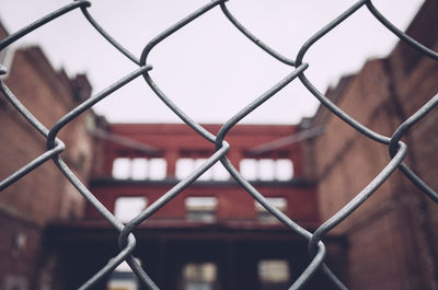 Full frame shot of chainlink fence against building