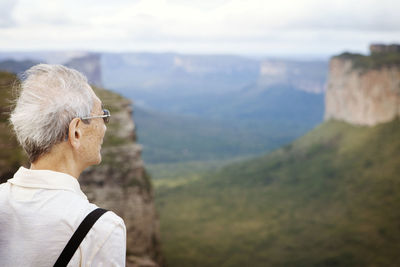 Senior man looking at cliffs