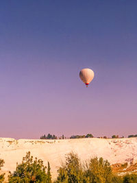 Hot air balloon flying over land