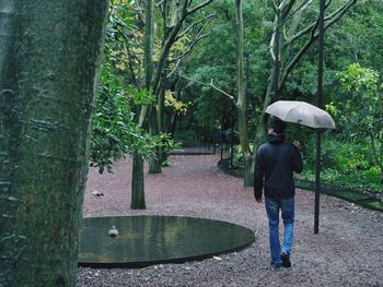 Full length of woman walking on footpath