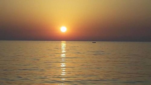 Scenic view of sea against sky at sunset