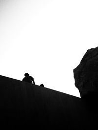 Low angle view of rocks against clear sky