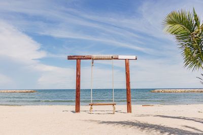Lifeguard hut on beach against sky