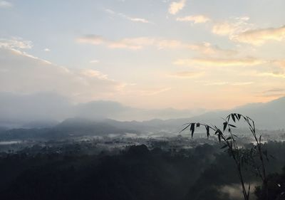 Scenic view of silhouette mountains against sky at sunset