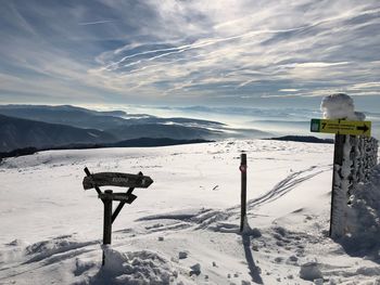 Scenic view of snow covered mountains against sky