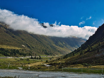 Scenic view of river amidst mountains against sky