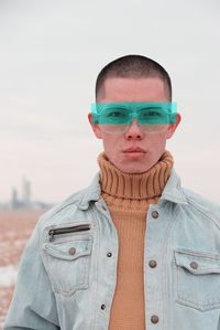 Portrait of young man wearing eyeglasses against clear sky