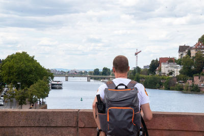 Rear view of man looking at river