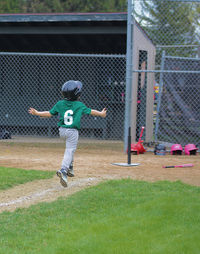 Full length of boy playing on field