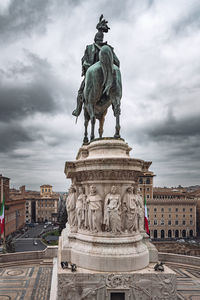 Low angle view of statue against cloudy sky