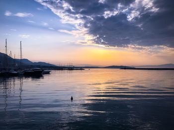 Silhouette of boats in sea during sunset