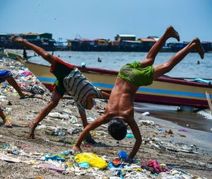 Shirtless boys playing at shore