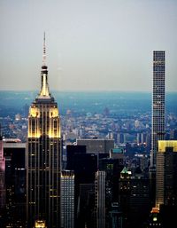 Aerial view of city lit up at sunset
