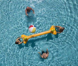 High angle view of people enjoying in swimming pool