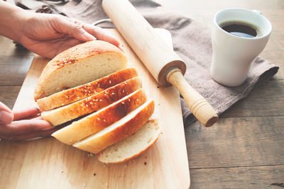 Close-up of woman preparing food on cutting board