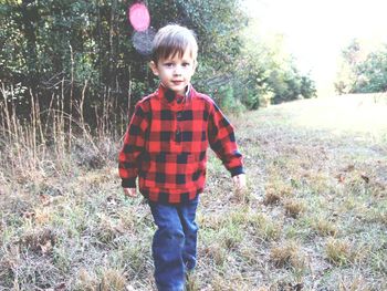 Full length of a boy standing on grass