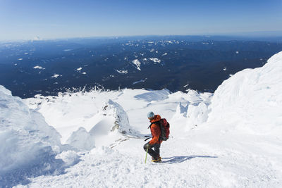 A man climbs down from the summit of mt. hood in oregon.