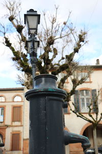 Low angle view of lamp post against sky