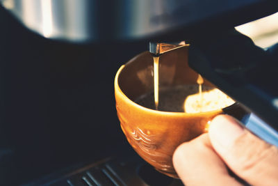 Close-up of hand holding coffee cup