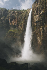 Powerfull cascade at wallaman fall during sunny day, queensland, australia