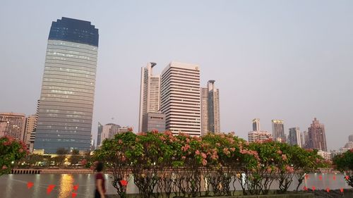 Modern buildings in city against clear sky