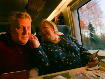 Portrait of man and woman using mobile phone