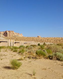 Built structure on desert against clear blue sky