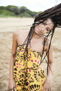 Midsection of young woman standing on beach