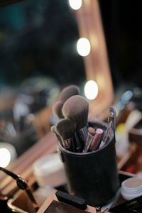 High angle view of make up brushes in container on table
