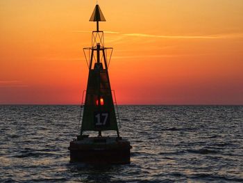 Sailboat on sea against sky during sunset