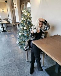 Woman sitting on chair at table