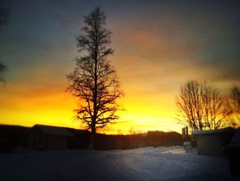 Scenic view of snow covered landscape at sunset