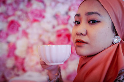 Close-up portrait of woman drinking water