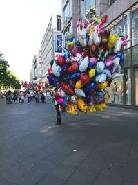 Multi colored balloons on street in city