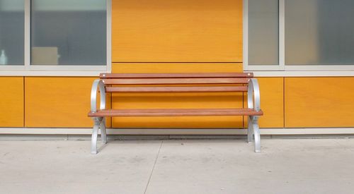 Empty chair against building
