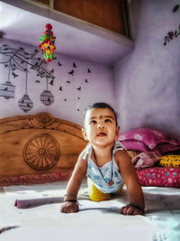 Portrait of cute girl on bed at home