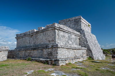 Low angle view of old ruins against clear blue sky