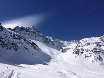 Scenic view of snowcapped mountains against clear blue sky