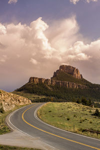 Road by mountain against sky