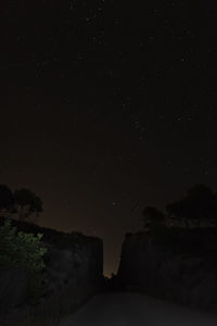 Low angle view of mountain against sky at night