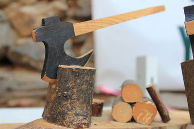 Close-up of axe on log