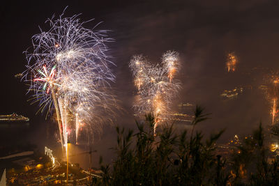 Low angle view of firework display at night