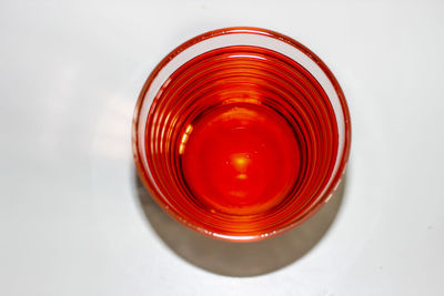 High angle view of wineglass on table against white background