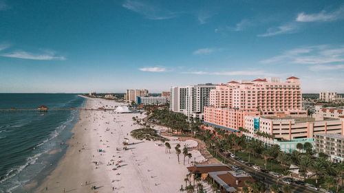 Buildings by sea against sky in city