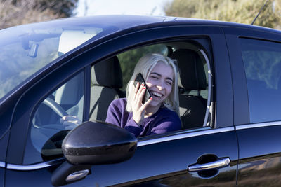 Portrait of young woman in car